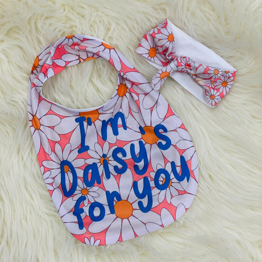 Baby Bib and Headband Set - Daisy Looking for a special baby gift? Here it is! This adorable bib says "I'm daisy's about you" With big white daisies and a pink background. It has a velcro attachment in the back. Along with this bib there's an adorable Pink daisy head wrap for your little one. Made with a soft polyester materiel. Just wrap around your baby's head and tie in a cute simple knot.   Laughing Giraffe One Size Pink 100% Polyester Daisy
