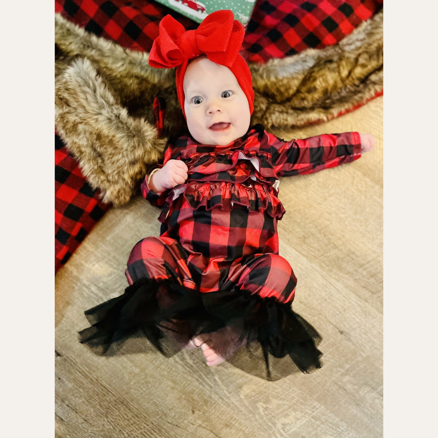                                        Ruffle Buffalo Plaid Romper  You can never have too much buffalo plaid! This romper is extra cute with the ruffles on the body and tulle ruffles at the feet!   Fits true to size. Polyester.