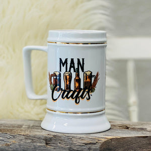 Man Crafts 28oz Beer Stein The design on this stein has four different beers in the middle with the phrase, "Man Crafts," around it. A great gift for Father's day!    28 oz Stein, 12-12.25" round X 6.25" Tall; White with Gold Trim. Dish washer Safe. For maximum span of image product we recommend hand washing. 