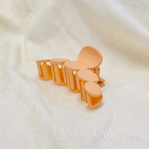 side view of peach claw clip